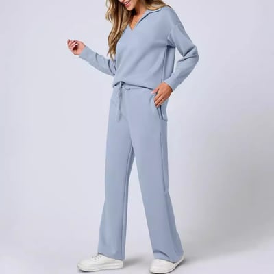 Woman in a modern jogging suit set with side slit detail and fitted leggings.