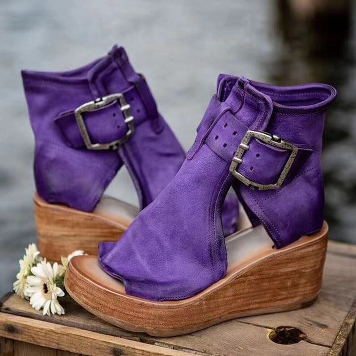 Female model wearing boho wedge sandals on a plain background.