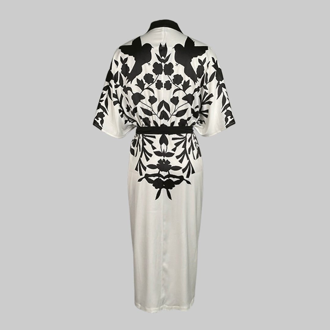 Deep V-neck floral dress with long sleeves on a plain background.