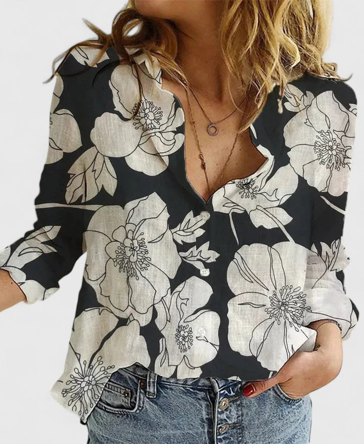  Woman in a relaxed fit button-up shirt with a curved hemline.