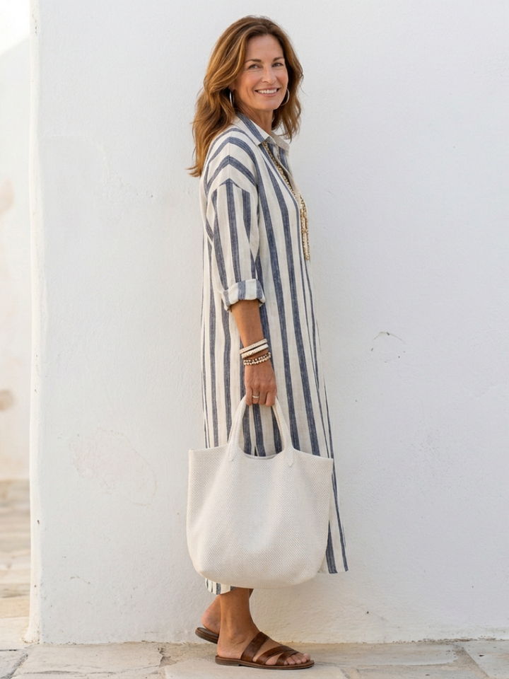 Female model wearing a polished mid-length formal outfit on a plain background.