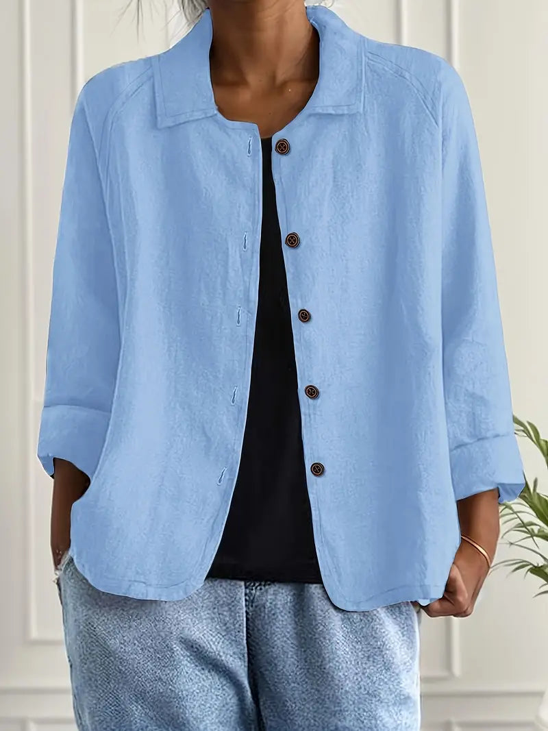 Woman wearing a lightweight layering top against a plain background.
