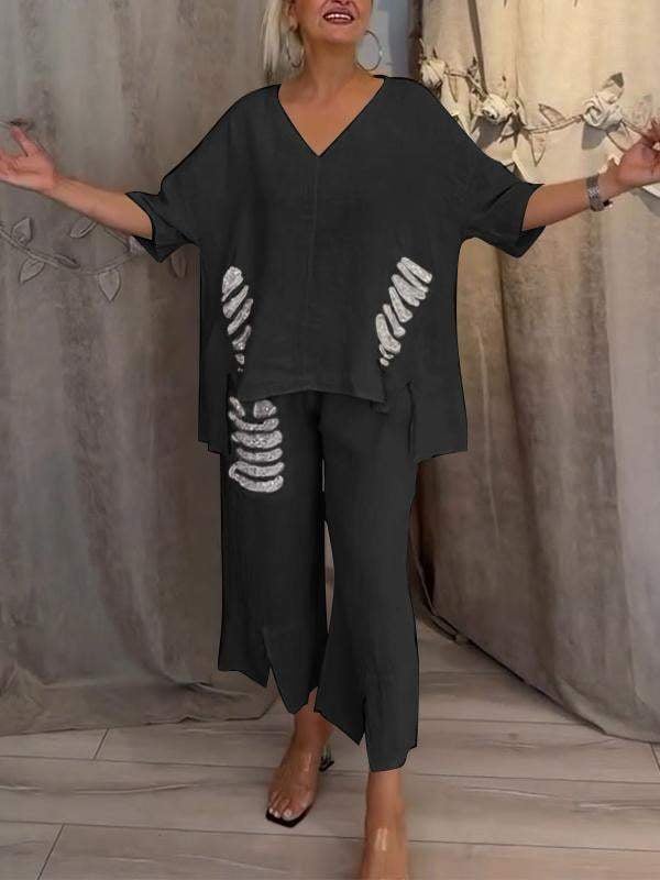 Woman wearing a two-piece outfit featuring a relaxed-fit top and comfortable wide-leg trousers.