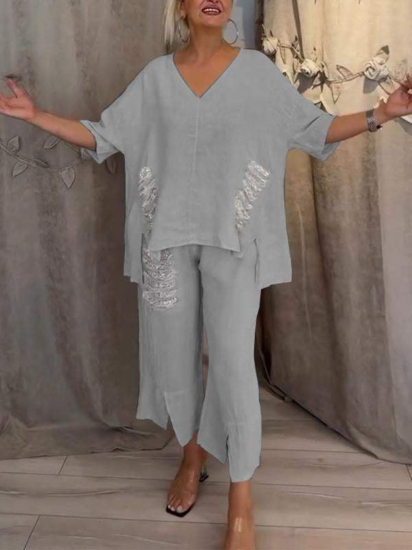 Woman in a coordinated summer outfit with a relaxed silhouette and flowing trouser design.