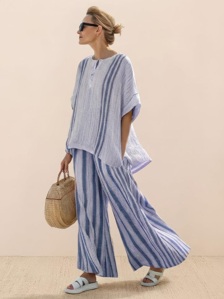 Woman wearing a longline tunic top paired with matching wide-leg trousers.