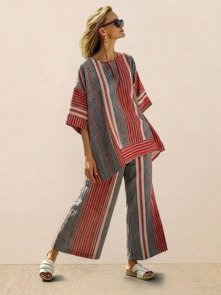 Woman in a striped two-piece ensemble featuring decorative embroidery and relaxed tailoring.