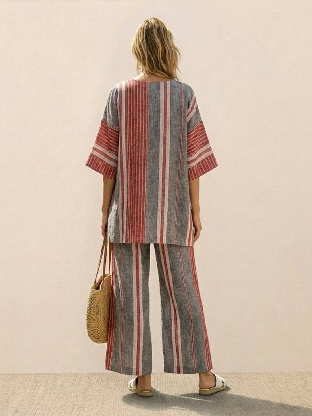Female model showcasing a matching tunic top and wide-leg trousers with embroidered accents.