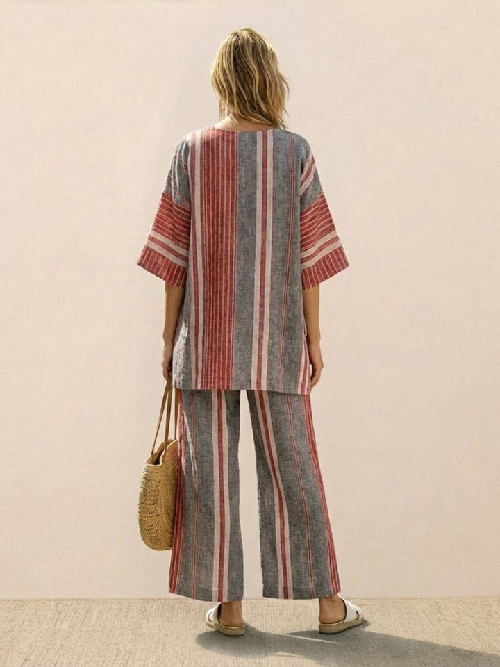 Female model showcasing a matching tunic top and wide-leg trousers with embroidered accents.