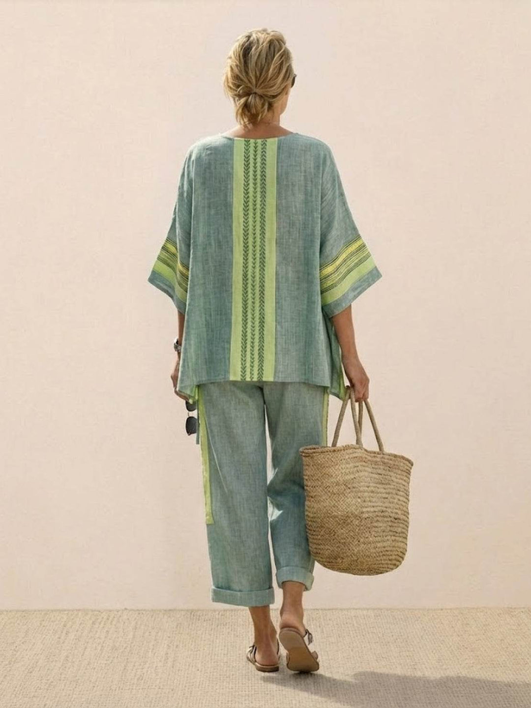 Female model showcasing a lightweight two-piece set with embroidered trim on a plain background.