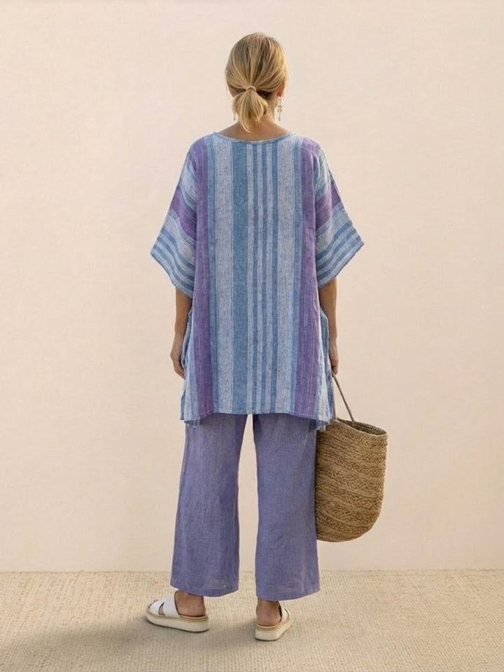 Female model in a coordinated warm-weather outfit with a long tunic and flowing trousers.