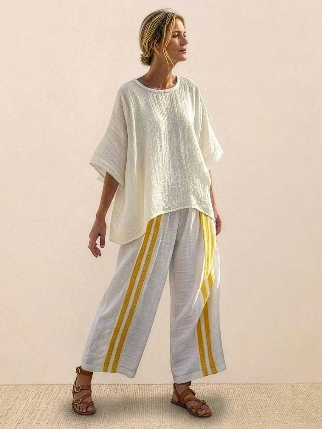 Woman in a coordinated striped two-piece set with embroidered neckline detailing.