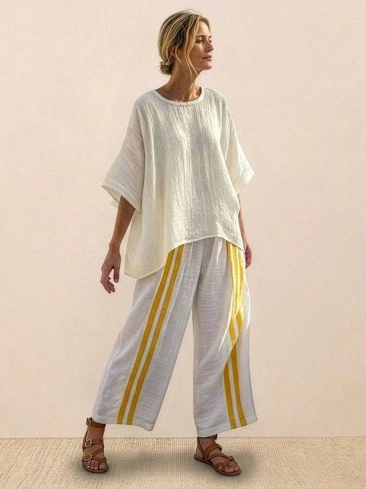 Woman in a coordinated striped two-piece set with embroidered neckline detailing.