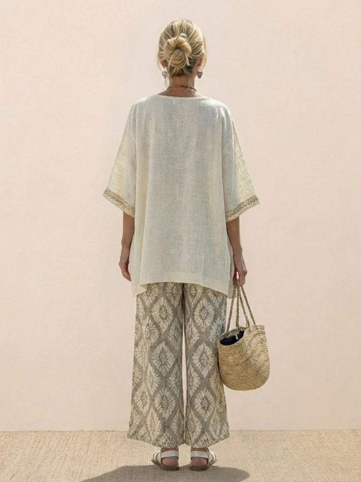 Female model in a matching tunic and trouser set featuring decorative embroidered accents.