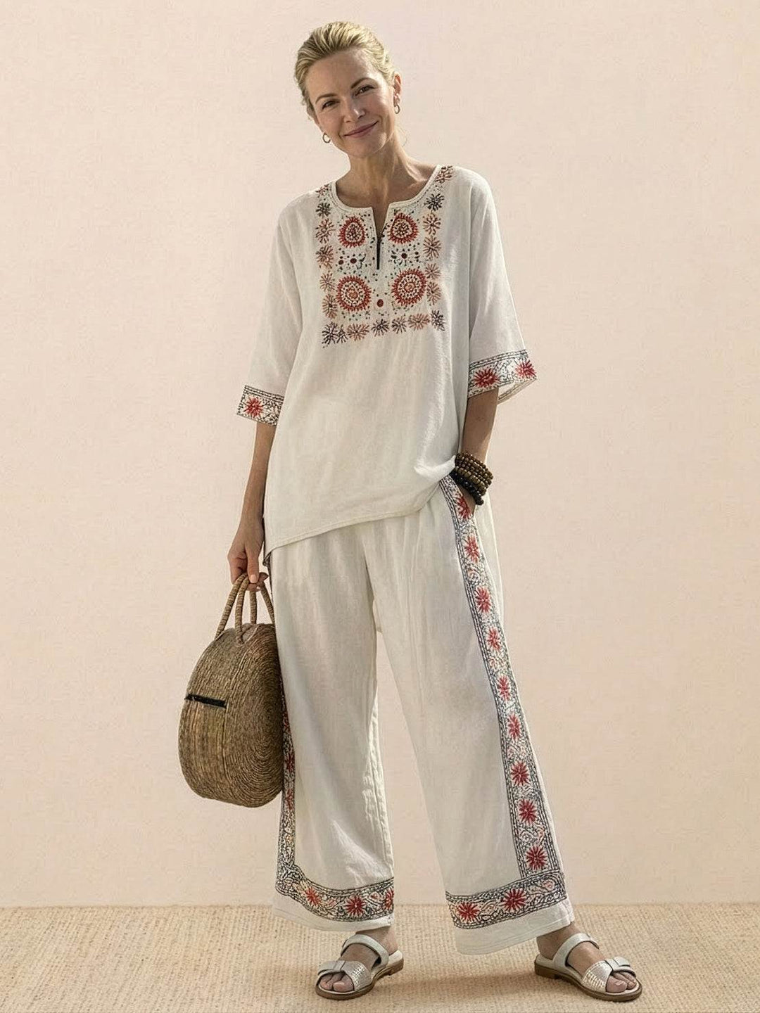 Female model showcasing an embroidered tunic and matching trousers with a relaxed silhouette.