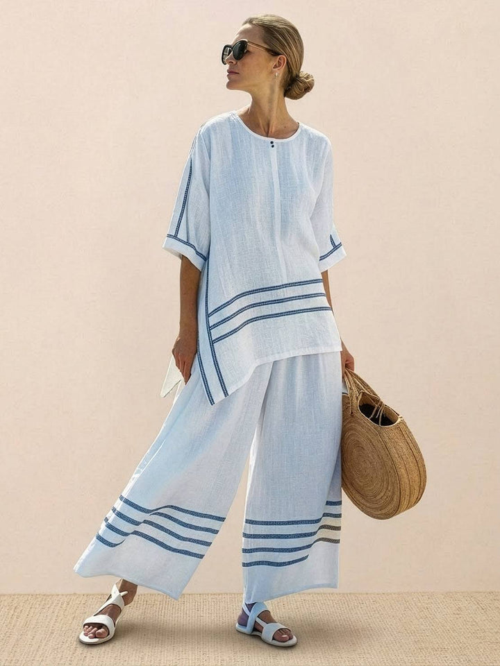 Woman styled in a relaxed embroidered outfit suitable for warm-weather occasions.