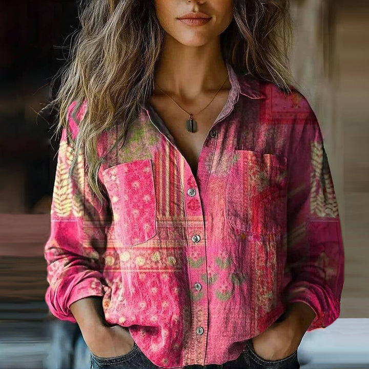  Female wearing a loose-fitting printed blouse with a flowing silhouette.