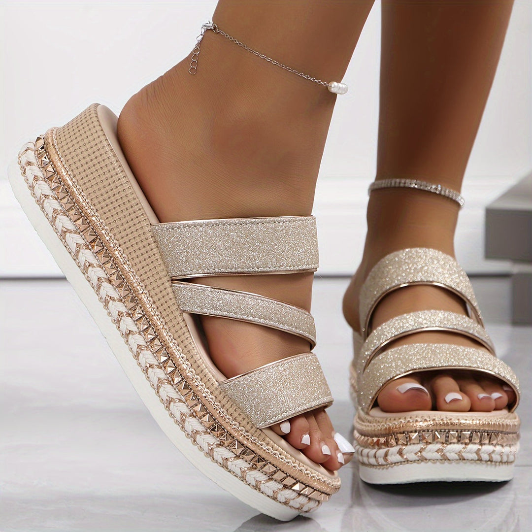 Female wearing strappy sandals with metallic detail and lightweight styling.