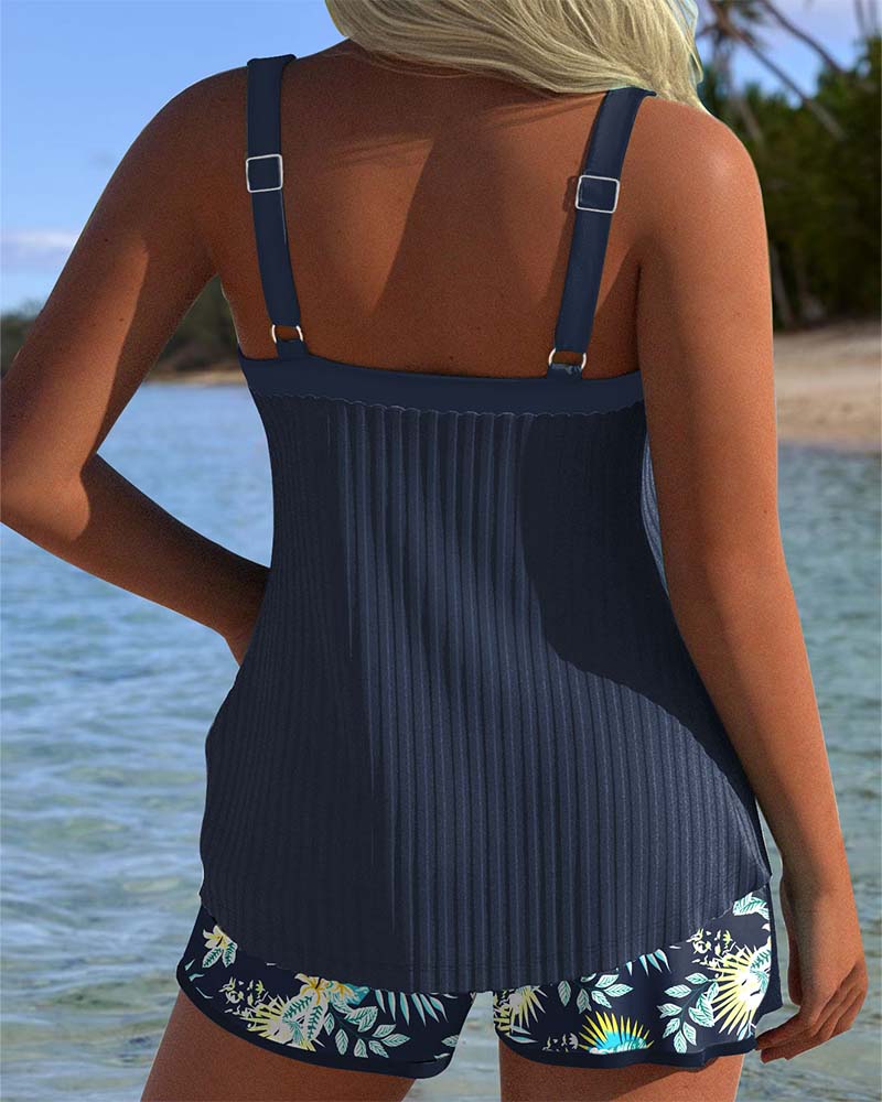 Woman posing in a striped two-piece swimwear set with lightweight shorts