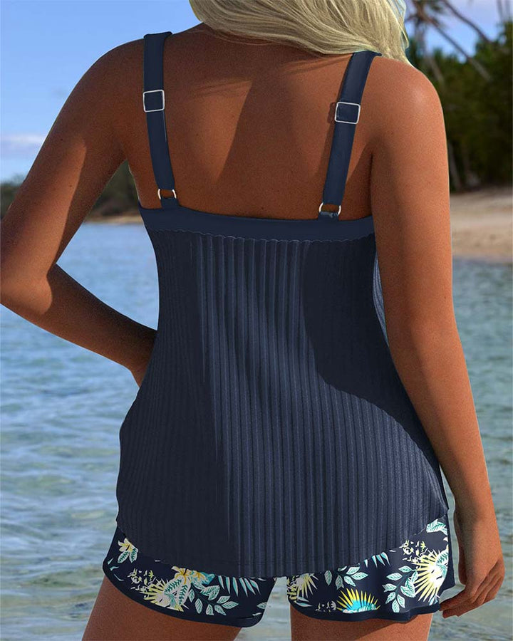 Woman posing in a striped two-piece swimwear set with lightweight shorts