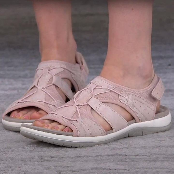 Female model wearing casual open-toe sandals for daily wear on a plain background.