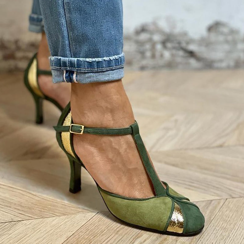 Green patchwork high heels with closed toe and T-strap on a plain background.