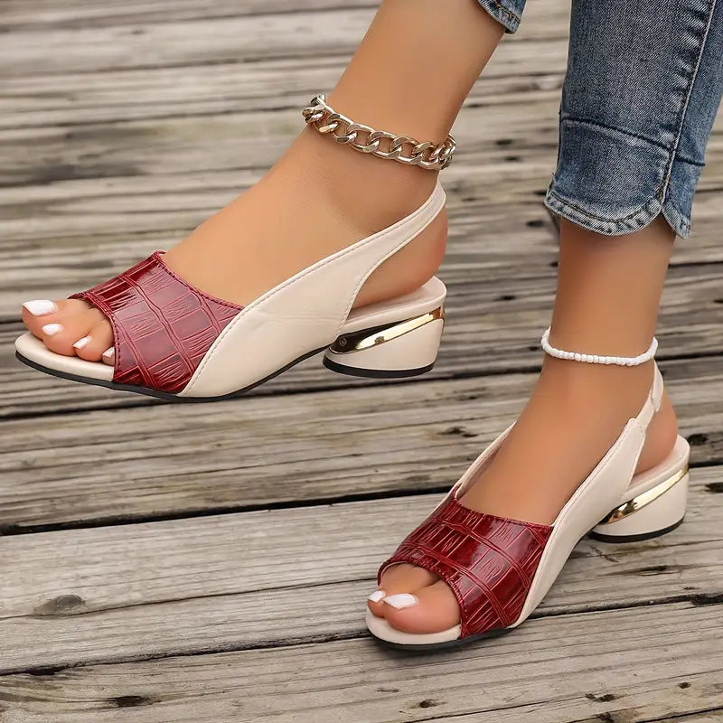 Female modelling textured block heel sandals with cushioned sole detail.