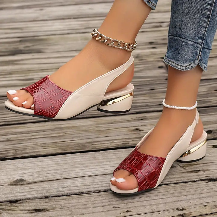 Female modelling textured block heel sandals with cushioned sole detail.