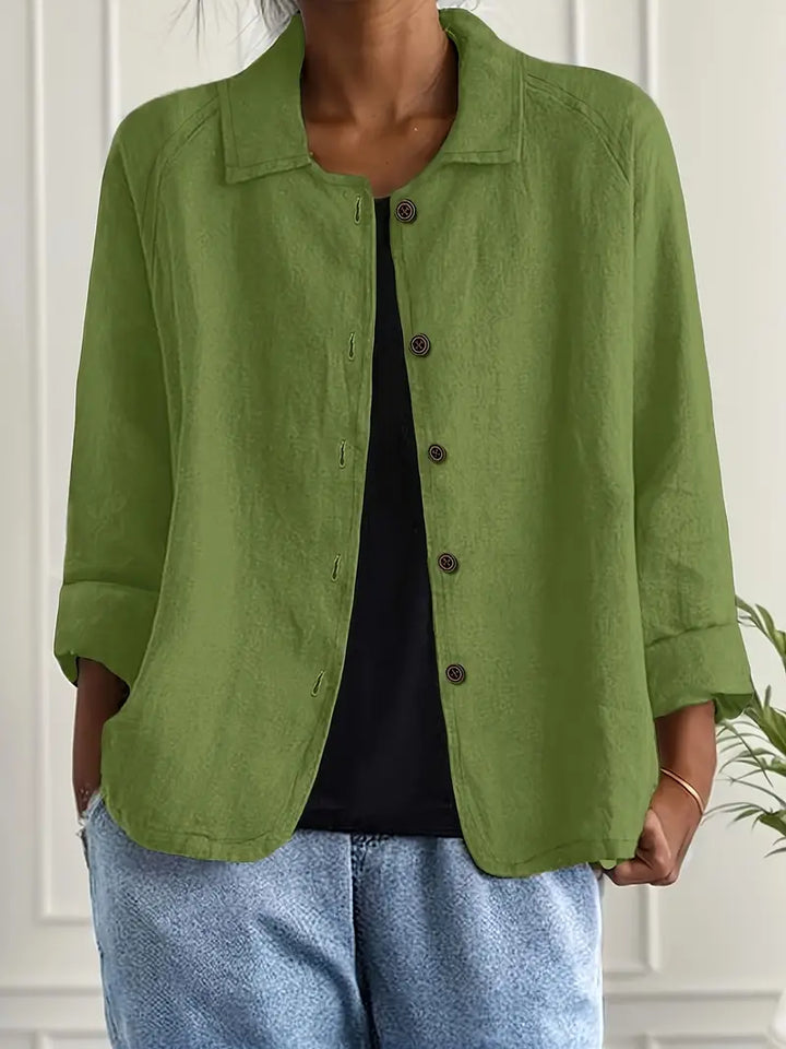  Woman modelling a relaxed fit layering top against a plain background.