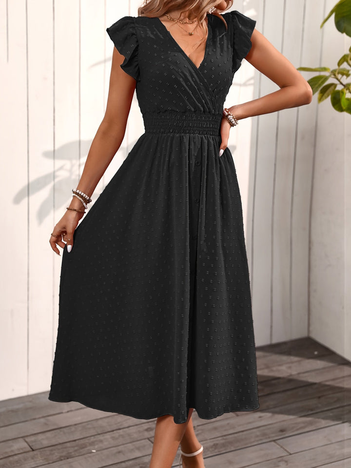  Woman in a ruffle sleeve dress with an elegant midi-length silhouette on a plain background.