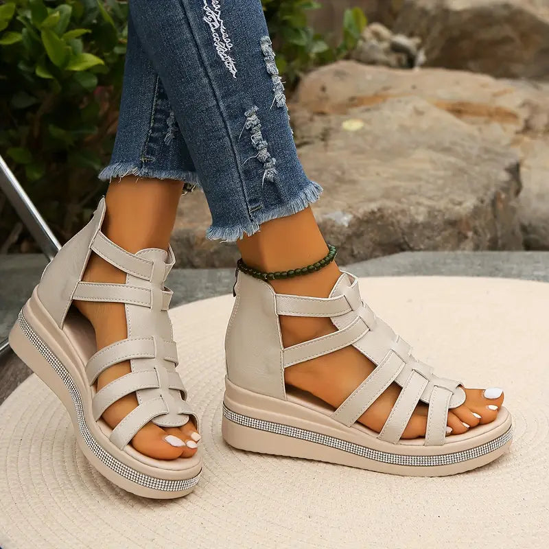 Female model wearing stylish summer sandals with decorative upper detailing.