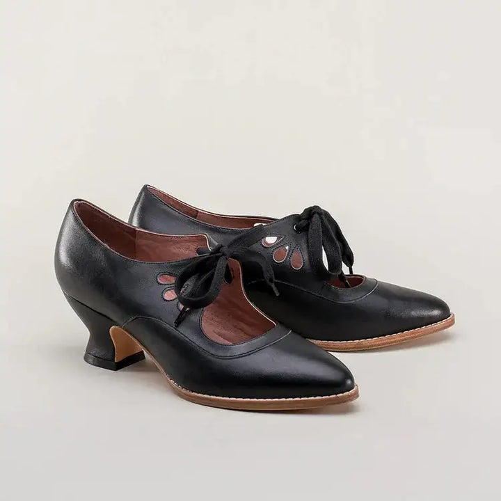 Retro dress heels with a plain background.