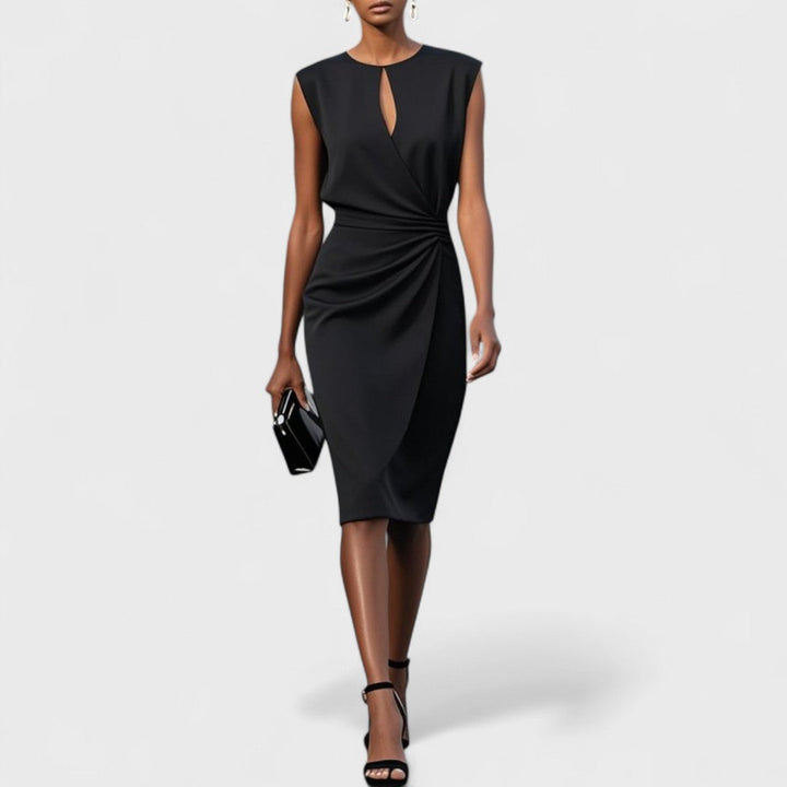  Female model in a graceful evening dress with a defined waistline on a plain background.