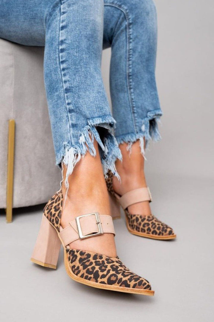 Leopard print heel sandals on a plain background with pointed toe and ankle strap.