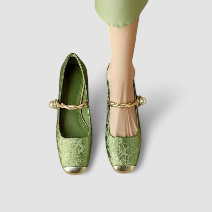 Woman showing stylish everyday shoes on a plain background.