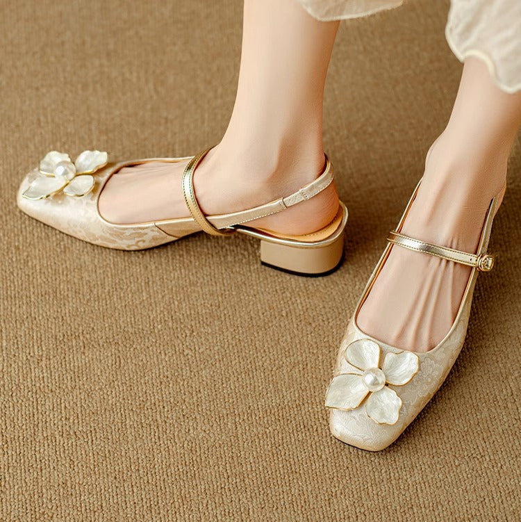 Female standing in adjustable strap slingback heels on a plain background.