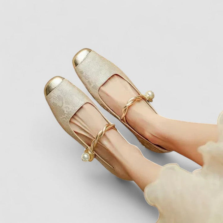 Woman modelling rounded toe Mary Jane shoes on a plain background.