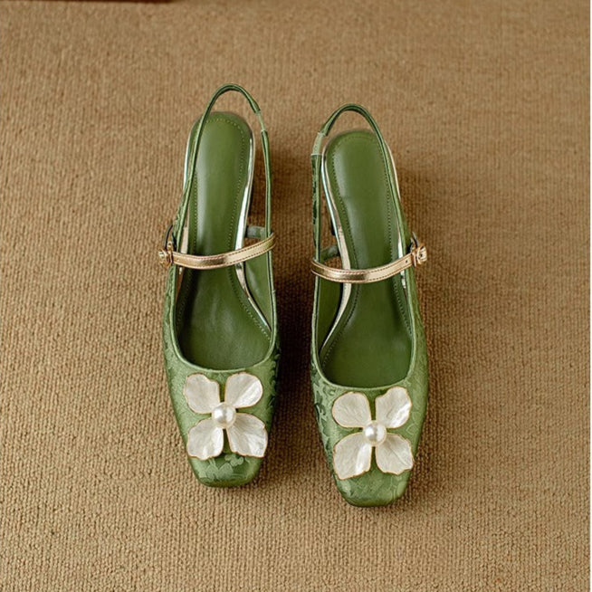 Mid block heel slingback pumps on a plain background.