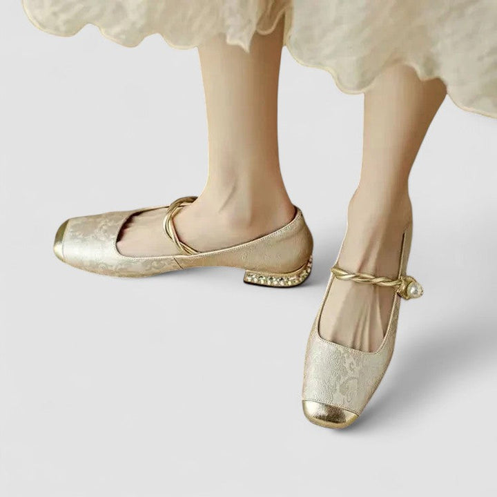 Female showcasing timeless strap footwear on a plain background.
