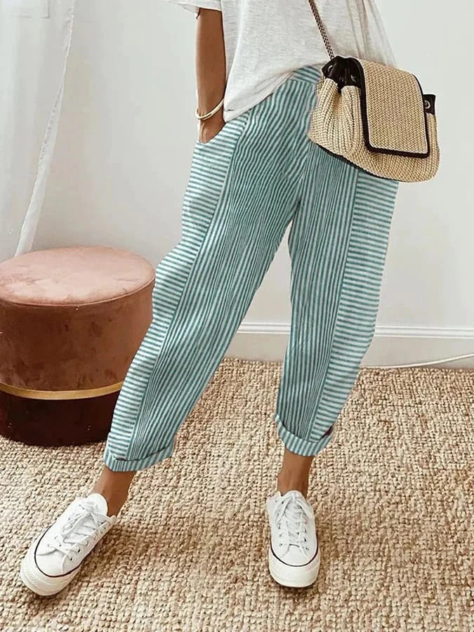 Female model in lightweight striped trousers with a flattering straight-leg silhouette.
