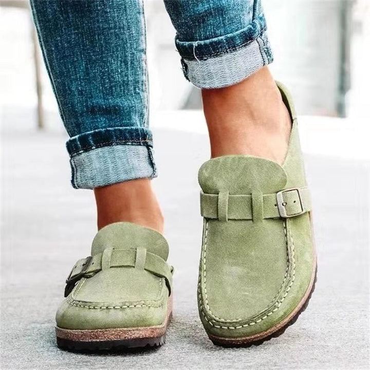 Model wearing buckle strap loafers designed for daily outfits on a plain background.