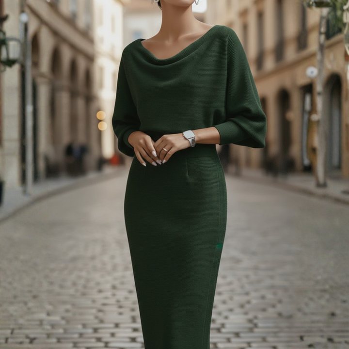 Female model styled in a long sleeve midi dress with fitted skirt against a plain background.