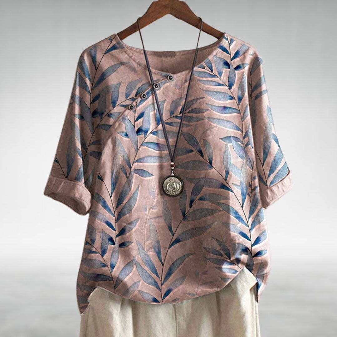  Female modelling a relaxed fit blouse with a flowing silhouette on a plain background.