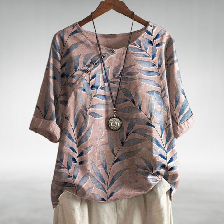  Female modelling a relaxed fit blouse with a flowing silhouette on a plain background.