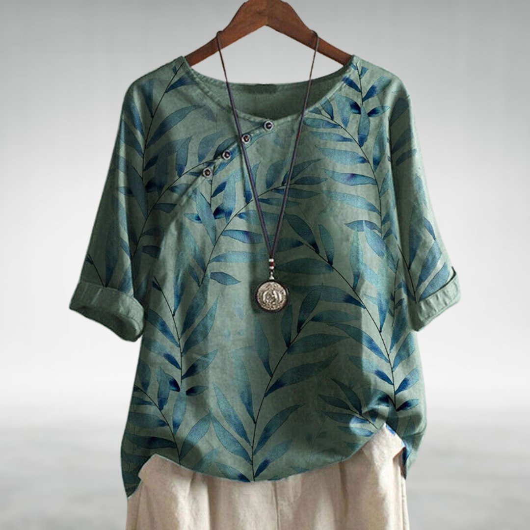 
Female wearing a casual blouse with a draped shape and modern button detail.