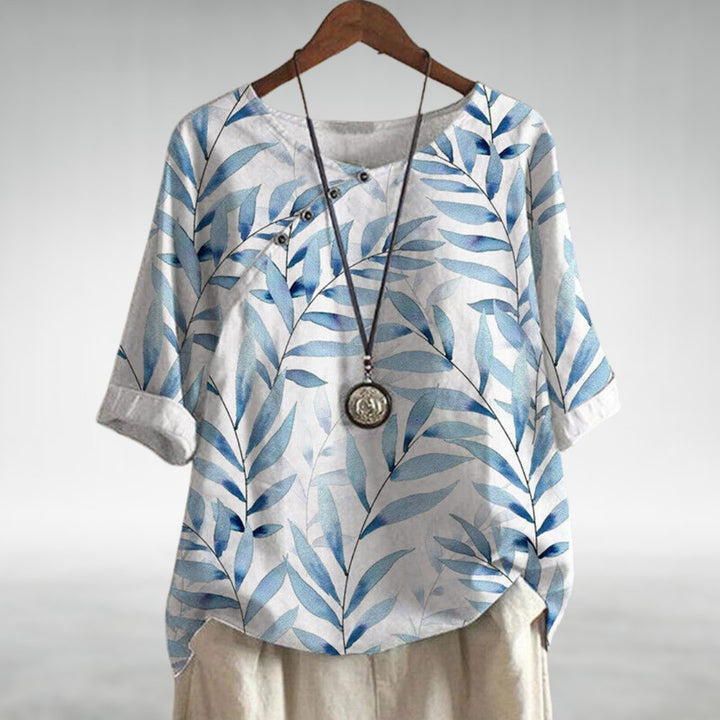  Woman in a long sleeve blouse featuring an angled button closure.