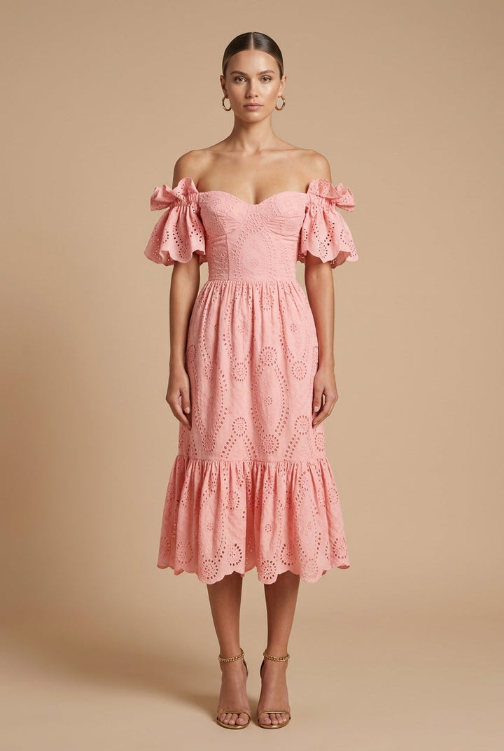 Female wearing an off-shoulder eyelet midi dress with puff sleeves against a plain background.