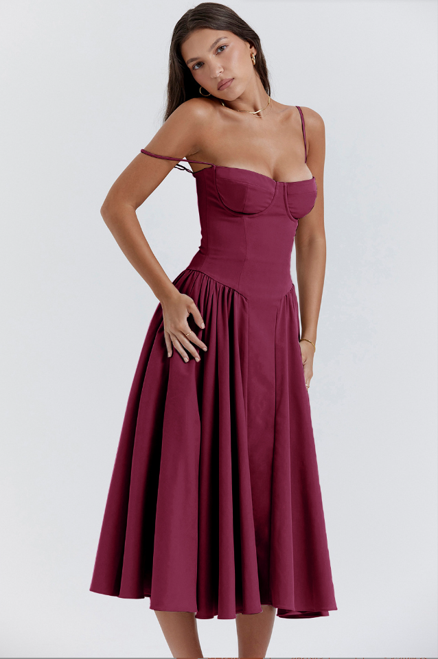 Model in a lightweight sleeveless dress designed for summer styling on a plain background.