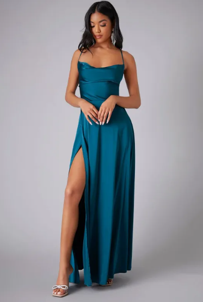 Female model wearing a satin cowl neck maxi dress against a plain background.