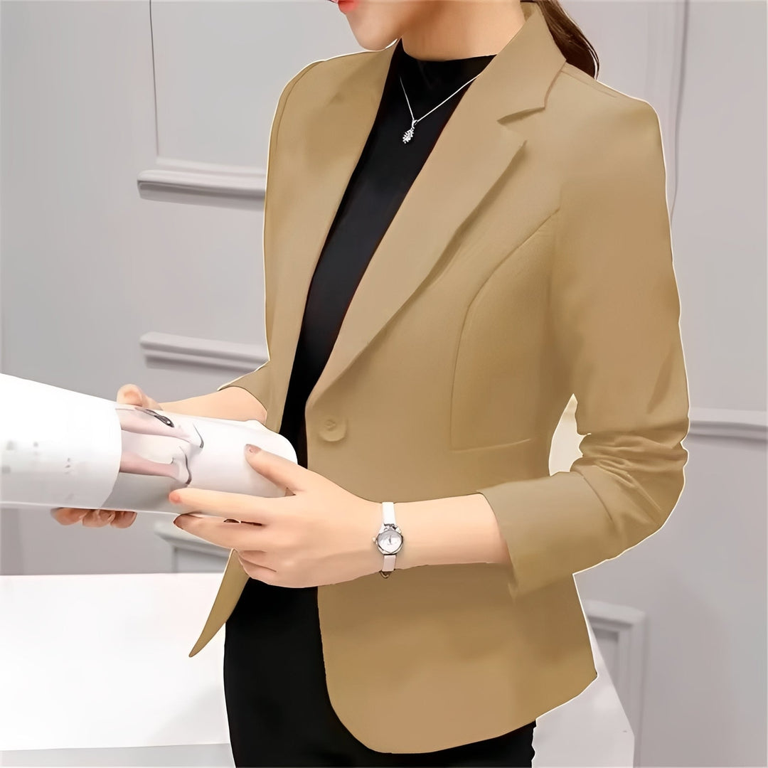 Woman wearing a fitted blazer with a lapel collar and single-button fastening.