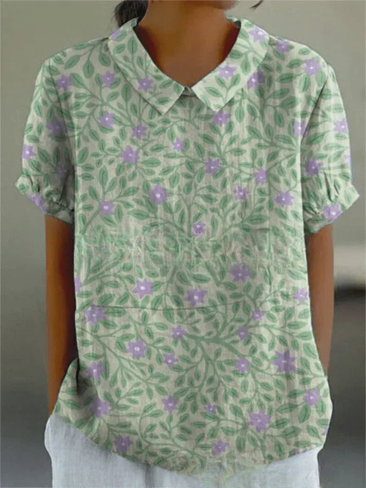 Model wearing a floral long sleeve blouse with casual styling on a plain background.